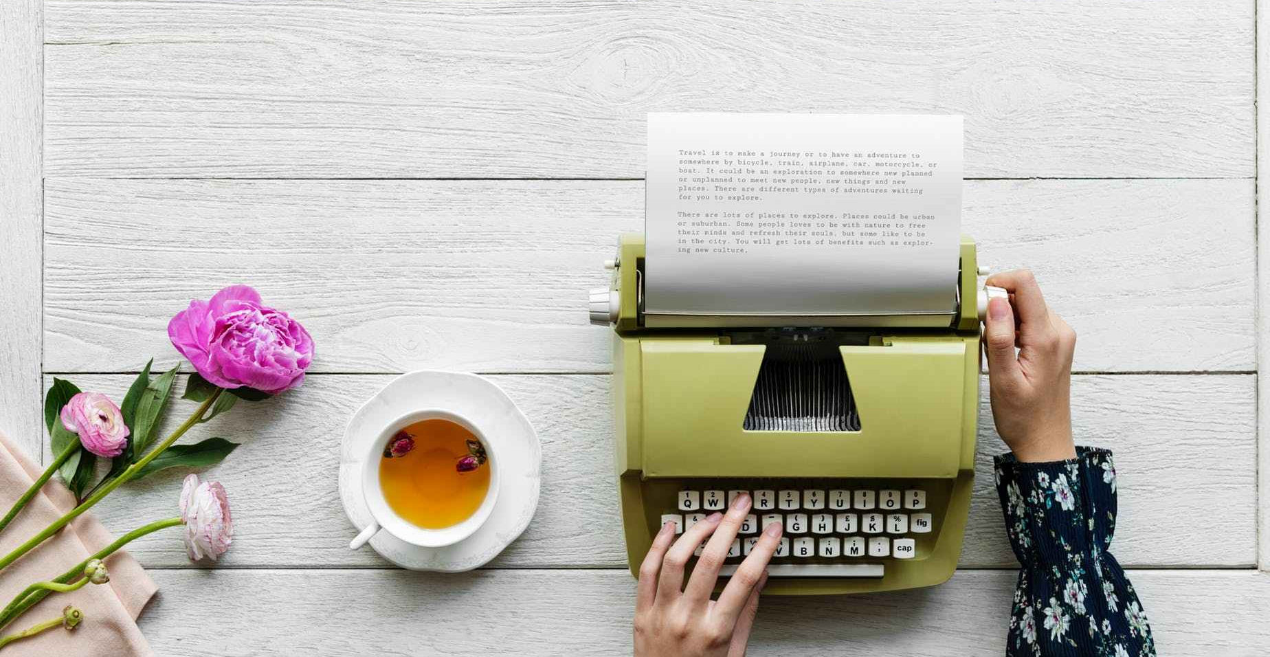 person using green typewriter